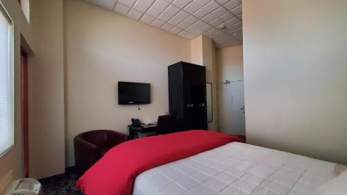 a bedroom with a bed with a red blanket at Lowell Inn in Stillwater