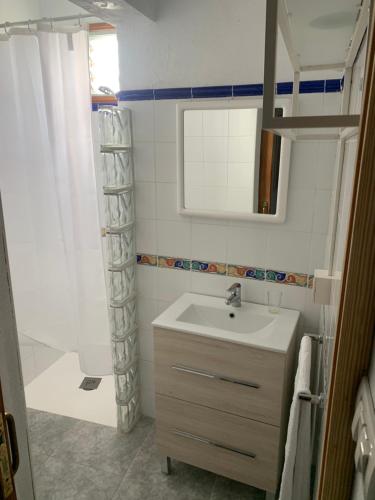a bathroom with a sink and a mirror and a shower at Rooftop Casa El Banco in El Charco