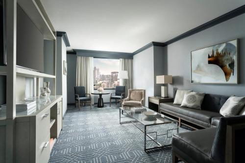 a living room with a couch and a table at Four Seasons Hotel Atlanta in Atlanta
