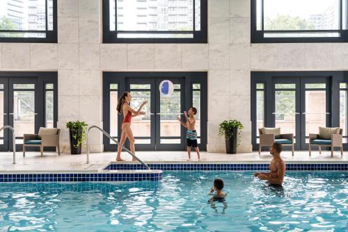 a group of people playing in a swimming pool at Four Seasons Hotel Atlanta in Atlanta