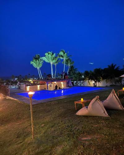 a swimming pool at night with blue lights at Ronco do Mar Cumbuco in Cumbuco
