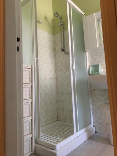 a walk in shower with a glass door in a bathroom at Trilocale sul Mare in Fano