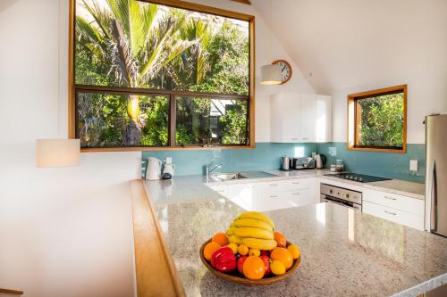 a kitchen with a bowl of fruit on a counter at Seascapes in Punakaiki