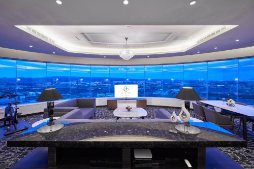 a living room with a large glass wall at Grand Bay Resort Hotel in Hengchun