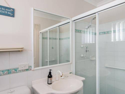 a white bathroom with a sink and a shower at Horizons 1 in Forster
