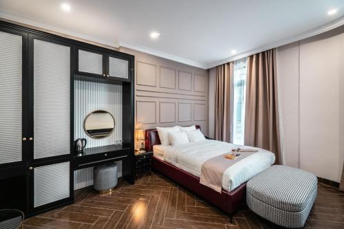 a hotel room with a bed and a mirror at Padona Hotel in Da Lat