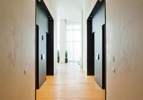 a hallway with a row of doors in a building at Oַ&O Group- Luxury Penthouse Jacuzzi Sea 36 Floor in Bat Yam