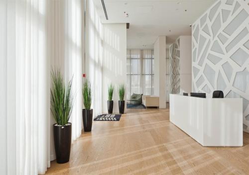 a lobby with potted plants and a reception desk at Oַ&O Group- Luxury Penthouse Jacuzzi Sea 36 Floor in Bat Yam