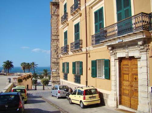 a group of cars parked in front of a building at Residenze Palazzo Pes in Cagliari
