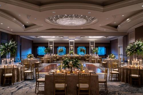 a ballroom with tables and chairs and a chandelier at Four Seasons Hotel Atlanta in Atlanta