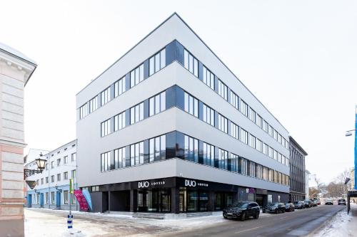a large white building on the side of a street at Cosy Duo Loft - self check-in in Tartu