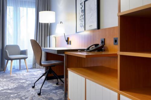 a hotel room with a desk and a phone at Hotel am Kloster in Werne an der Lippe