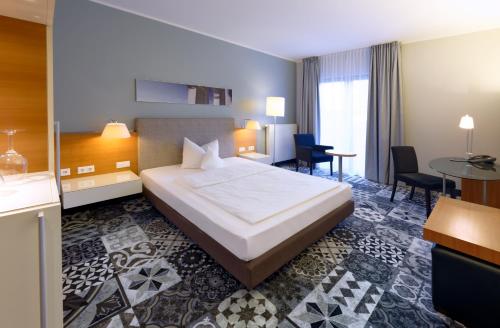 a hotel room with a bed and a table at Hotel am Kloster in Werne an der Lippe