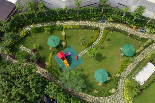 an overhead view of a garden with umbrellas at Somerset Sudirman Jakarta in Jakarta