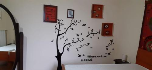 a bedroom with a tree with musical notes on a wall at Antico Convento in Garessio