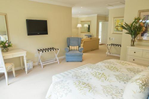 a bedroom with a bed and a tv on the wall at Last Word Constantia in Cape Town