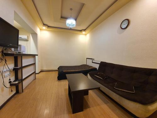 a living room with a couch and a tv at Tatev Apartments in Yerevan