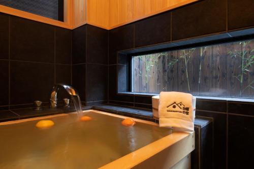 a kitchen with a sink and a window at Shirakabanoyado - Seiran in Osaka