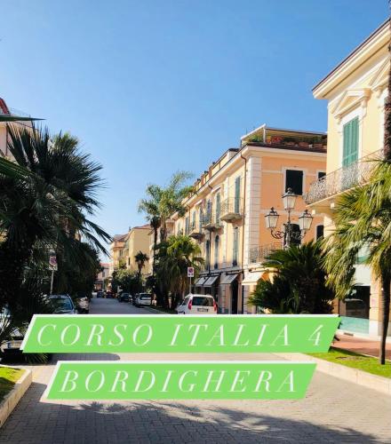 a street in a town with a sign that reads corosa infinityario at Corso Italia 4 in Bordighera
