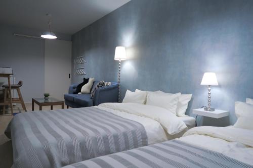 Ένα ή περισσότερα κρεβάτια σε δωμάτιο στο neko neko apartment