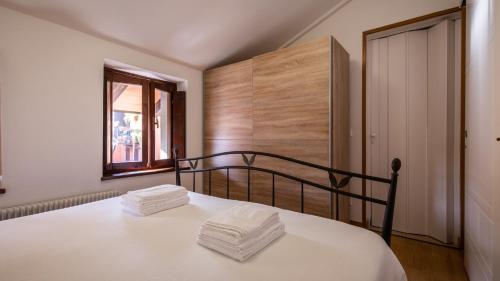 a bedroom with a bed with white sheets and a window at Italianway - Castellana 68 in Udine