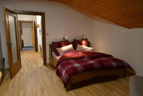 a bedroom with a large bed in a room at Haus am Römerbad in Bad Kleinkirchheim