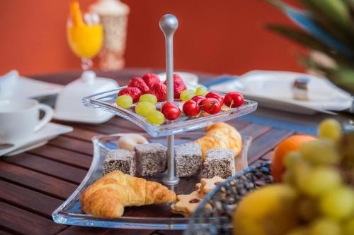 a table topped with a tray of fruit and pastries at Villa Providenca in Šibenik