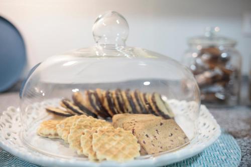 a glass plate with cookies and crackers on a table at Casa Shelly Hospedería in Vejer de la Frontera