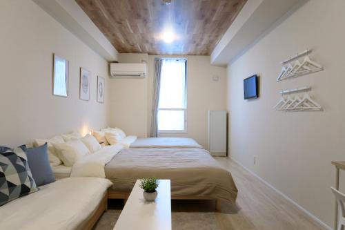 Ένα ή περισσότερα κρεβάτια σε δωμάτιο στο neko neko apartment