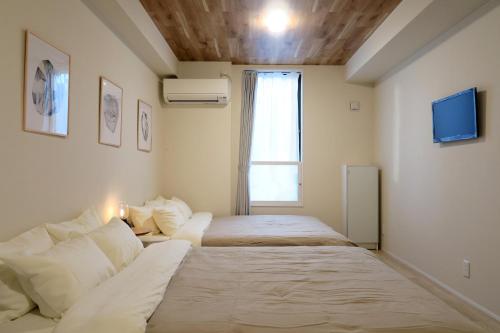 Ένα ή περισσότερα κρεβάτια σε δωμάτιο στο neko neko apartment