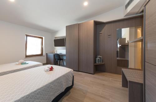 A bed or beds in a room at Hotel Da Si-Si