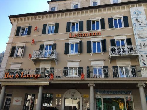 a building with a sign for a bar and lounge at Neptun 3 - im Zentrum von Bad Ragaz, mit kl. Balkon in Bad Ragaz