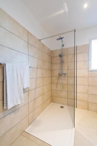 a bathroom with a shower with a glass door at Résidence U Manellu in Santa-Reparata-di-Balagna