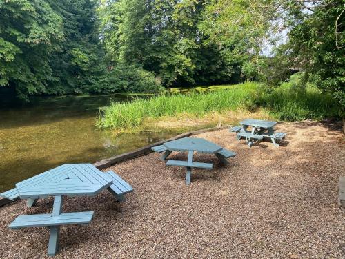 a group of picnic tables next to a river at Deeping Stage in Market Deeping