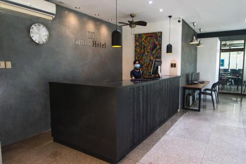 a man sitting at a counter in a restaurant at DG Grami Hotel in Manila