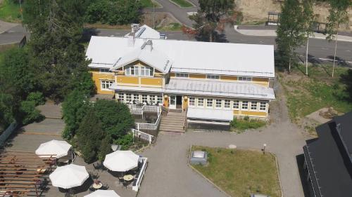 an overhead view of a yellow building with a white roof at Boutique hotel Sawohouse in Kuopio