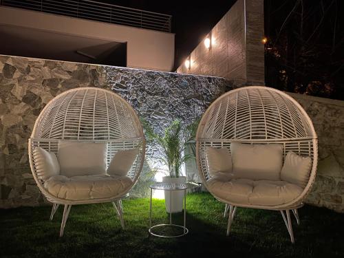 two rattan chairs sitting in a yard with a table at RIA Lungomare in Rijeka