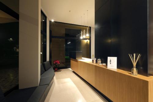 a room with a long counter with a mirror at Hotel Touring in Ferrara