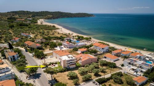 an aerial view of a beach with buildings and the ocean at Amversa's House in Potos