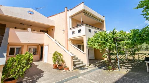 a house with a staircase in front of it at Amversa's House in Potos