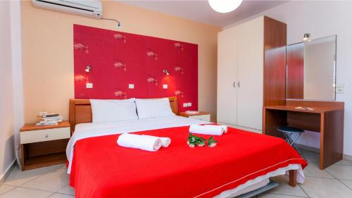 a bedroom with a red bed with a red headboard at Amversa's House in Potos