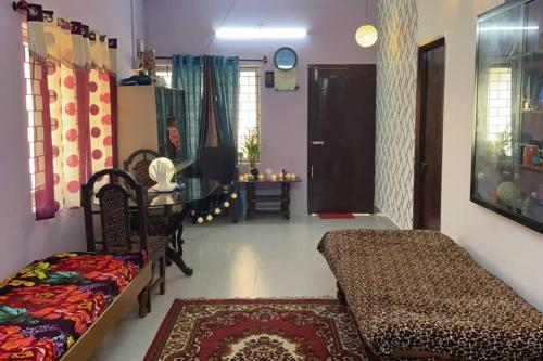 a living room with a couch and a table at SHREYAS - Authentic Mangalore Homestay(2BHK house) in Mangalore
