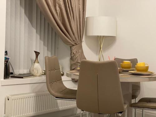 a dining room with a table and chairs at HLA Holytown in Mossend