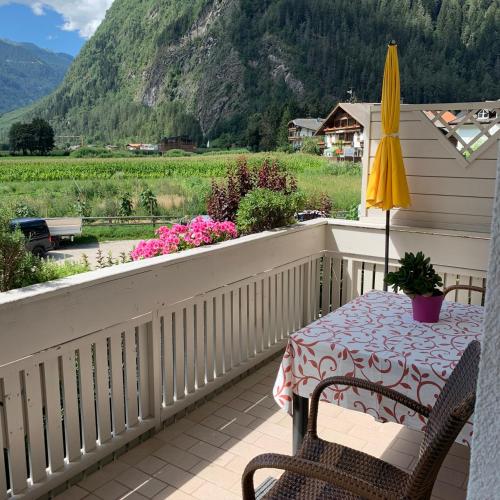 a table and chairs on a balcony with a view at Haus Martina in Sand in Taufers