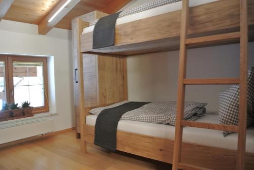 a bedroom with a bunk bed and a window at Appartement Seespitzhof in Scheffau am Wilden Kaiser