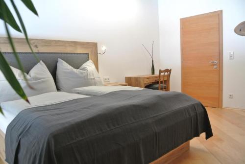a bedroom with a large bed with white pillows at Appartement Seespitzhof in Scheffau am Wilden Kaiser