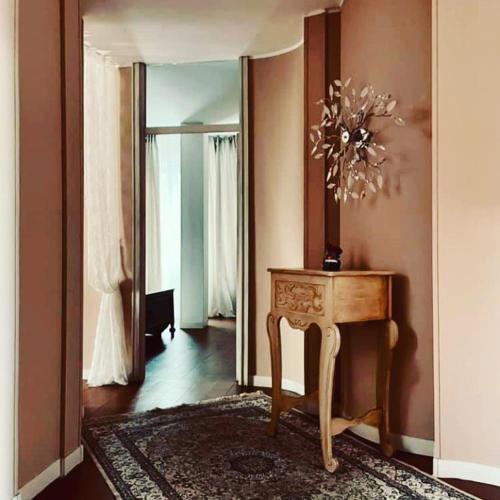 a room with a table and a mirror on the wall at Villa Tanya in Trebbiantico