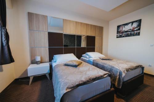 a hotel room with two beds and a window at Hotel Brcko Gas Prijedor in Prijedor