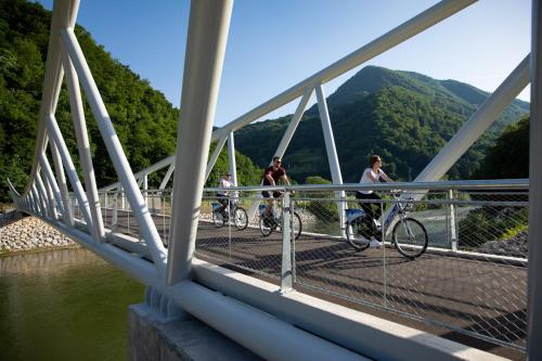 a group of people riding bikes on a bridge at Hotel Thermana Park Laško**** Superior in Laško
