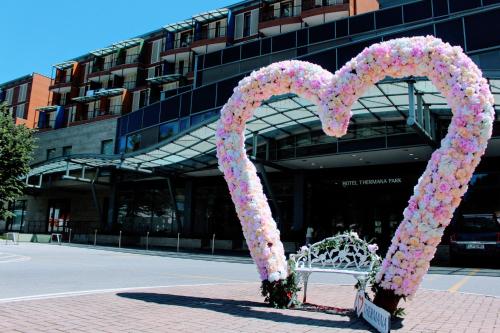 a heart made out of flowers in front of a building at Hotel Thermana Park Laško**** Superior in Laško